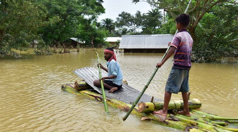 Hojai: Villagers rowing a makeshift raft past submerged houses at a flood-affected village in Hojai District, Saturday, May 30, 2020. (PTI Photo)(PTI30-05-2020_000105B)